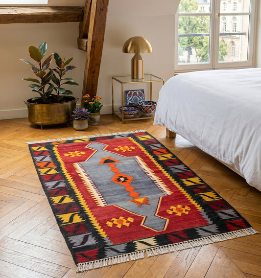 Petit tapis kilim ancien Emirdag (165 x 88 cm) aux rayures horizontales et motifs géométriques colorés, disposé dans un salon moderne à Montpellier. Ce tissage d'Anatolie de 60 ans d'âge combine laine et coton pour apporter une touche d'artisanat authentique et chaleureuse.