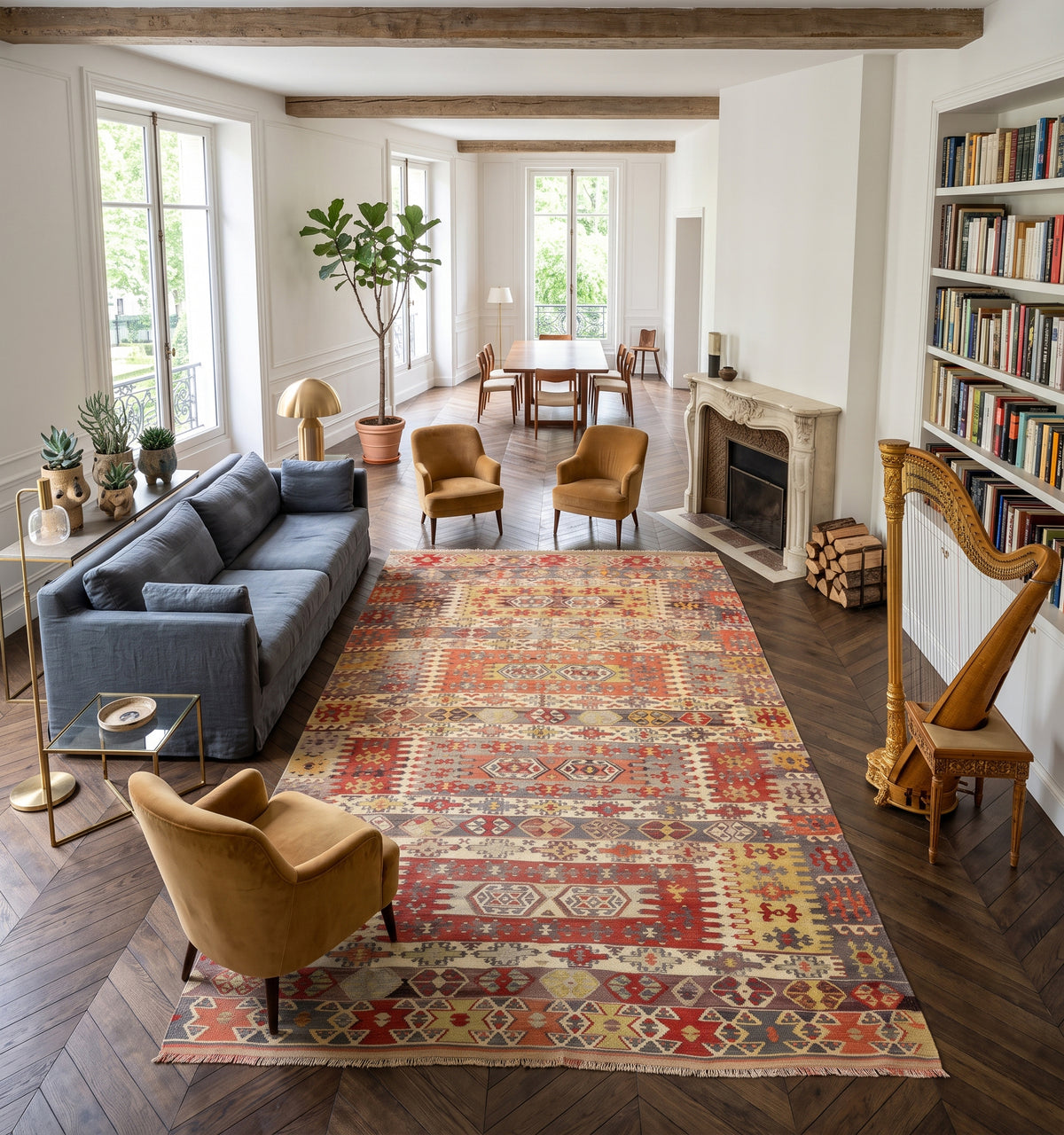 Tapis kilim ancien d'Aydın, tissé main en laine par des nomades d'Anatolie, bandes de motifs losangés rouge et safran patinés par le temps, posé dans un hôtel particulier à Neuilly face à une cheminée en pierre sculptée et une harpe