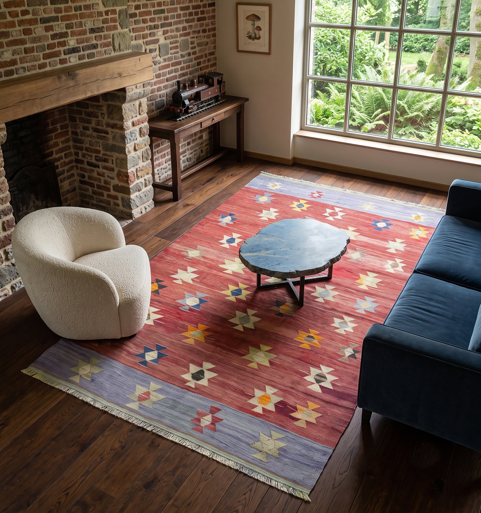 Tapis kilim d'Anatolie vintage aux tons rouge, ocre et géométriques complexes, placé dans un salon chaleureux. La scène se déroule dans une pièce lumineuse, dotée d'une grande baie vitrée offrant une vue panoramique sur les collines boisées et verdoyantes des Ardennes belges. 