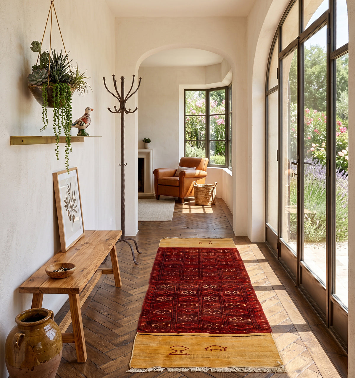 Tapis kilim tissé main aux bandes safran et rouge grenat, motifs tribaux tissés à la manière des nomades d'Anatolie, posé dans un couloir voûté à Aix-en-Provence face à un jardin de lavande