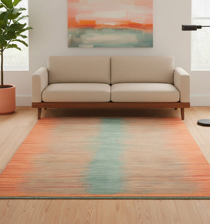 Tapis de salon en laine Art Deco avec un dégradé horizontal orange et une bande centrale bleu clair (202 x 149 cm) placé devant un canapé beige moderne et une peinture abstraite assortie